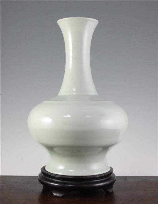 A Chinese celadon glazed bottle vase, Yongzheng mark, late 19th/early 20th century, ebonised wood stand.